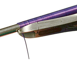 Wire cutters trimming the end of the coiled wire